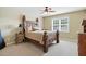 A traditional bedroom featuring a carved wooden bed frame and neutral decor at 164 Avocet Ln, Clayton, NC 27520
