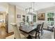 Elegant dining room with large wooden table, custom lighting fixture, and a view of the backyard at 164 Avocet Ln, Clayton, NC 27520