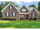 Charming two-story brick home with a manicured lawn and neatly trimmed hedges at 164 Avocet Ln, Clayton, NC 27520