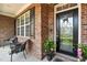 Welcoming front porch featuring stylish seating and a decorative glass front door at 164 Avocet Ln, Clayton, NC 27520