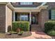 Inviting front porch with brick steps, tidy shrubs, and a decorated front door at 164 Avocet Ln, Clayton, NC 27520