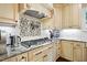 Close up of the kitchen featuring granite countertops, tile backsplash, and stainless steel appliances at 164 Avocet Ln, Clayton, NC 27520