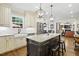 Open kitchen showcasing granite countertops, pendant lighting, stainless steel appliances, and hardwood floors at 164 Avocet Ln, Clayton, NC 27520