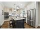 Well-appointed kitchen featuring custom cabinets, stainless steel appliances, a large island, and hardwood floors at 164 Avocet Ln, Clayton, NC 27520