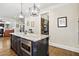 Spacious kitchen with granite countertops, stainless steel appliances, an island, and modern pendant lighting at 164 Avocet Ln, Clayton, NC 27520