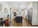 Open kitchen featuring custom cabinets, stainless steel appliances, a large island with modern pendant lighting at 164 Avocet Ln, Clayton, NC 27520
