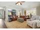 Spacious living room featuring a leather sofa, patterned rug, and elegant decor at 164 Avocet Ln, Clayton, NC 27520