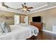 Spacious main bedroom with dark wood floors, fan, and modern brown dresser with television at 164 Avocet Ln, Clayton, NC 27520