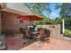 Outdoor kitchen area with a built-in grill, dining table, and chairs on a brick patio at 164 Avocet Ln, Clayton, NC 27520