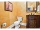 Unique powder room with decorative walls, ornate vanity, and wooden floors at 164 Avocet Ln, Clayton, NC 27520