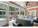 Bright sunroom with brick accent wall and access to an outdoor deck at 164 Avocet Ln, Clayton, NC 27520