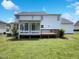 The backyard offers a screened porch and deck for outdoor entertainment at 17 Ballard Ct, Durham, NC 27712
