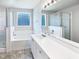 Bright bathroom featuring a large tub, shower, and a spacious vanity at 17 Ballard Ct, Durham, NC 27712