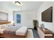 Modern bedroom with a large bed, television, and sleek minimalist décor at 17 Ballard Ct, Durham, NC 27712
