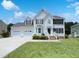 Charming two-story home featuring a three-car garage, manicured lawn and inviting front porch at 17 Ballard Ct, Durham, NC 27712