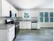 Bright kitchen features white cabinets, stainless steel appliances, and modern flooring at 17 Ballard Ct, Durham, NC 27712