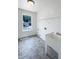 A laundry room features a sink and shelves, with a window for natural light at 17 Ballard Ct, Durham, NC 27712