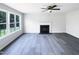 Bright living room showcases a fireplace, ceiling fan and large windows at 17 Ballard Ct, Durham, NC 27712