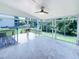 The sunroom offers bright views of backyard with glass windows and a ceiling fan at 17 Ballard Ct, Durham, NC 27712