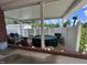 Covered patio area perfect for entertaining, complete with outdoor furniture and partial view of the backyard at 1828 Fletchers Chapel Rd, Durham, NC 27703