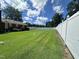 Spacious backyard with well-kept lawn and tall white fence, offering privacy and room for outdoor activities at 1828 Fletchers Chapel Rd, Durham, NC 27703