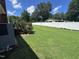 Expansive fenced backyard featuring a well-maintained lawn and a utility box on the side of the house at 1828 Fletchers Chapel Rd, Durham, NC 27703