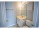 A compact bathroom with a toilet, vanity, mirror, and storage cabinet at 19 Cheltenham Dr, Clayton, NC 27520