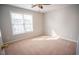 Bright bedroom with a ceiling fan and large window offering plenty of natural light at 19 Cheltenham Dr, Clayton, NC 27520