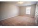 Carpeted bedroom with neutral paint, a ceiling light fixture, and a window at 19 Cheltenham Dr, Clayton, NC 27520