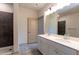 Elegant bathroom features modern shower with tile surround and double sink vanity at 2305 Gathering Sq Ct, Fuquay Varina, NC 27526