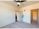 Bright bedroom featuring carpet, modern ceiling fan, and closet with doors at 2305 Gathering Sq Ct, Fuquay Varina, NC 27526