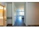 Bright hallway featuring modern flooring and a view into the open-concept kitchen and living area at 2305 Gathering Sq Ct, Fuquay Varina, NC 27526