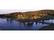 Panoramic aerial view of the lakeside property surrounded by lush greenery and a pristine lake at 23106 Umstead, Chapel Hill, NC 27517