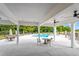 Shaded poolside seating and large columns frame a beautiful view of the community pool at 235 N Maple Walk Dr # 220, Garner, NC 27529