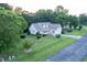 An aerial view of a large, light yellow house with a large yard with well-maintained grass at 237 Water Front Ln, Timberlake, NC 27583
