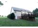 Wide backyard showcasing house siding, walkout basement, and gas tank at 237 Water Front Ln, Timberlake, NC 27583