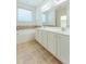 Bright bathroom featuring a soaking tub, double vanity, and tile flooring at 237 Water Front Ln, Timberlake, NC 27583
