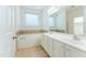 Bright bathroom featuring a soaking tub, double vanity, and tiled floors at 237 Water Front Ln, Timberlake, NC 27583