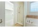 Bright bathroom featuring a shower, soaking tub, and walk-in closet at 237 Water Front Ln, Timberlake, NC 27583
