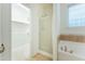 Bright bathroom featuring a shower, soaking tub, and walk-in closet at 237 Water Front Ln, Timberlake, NC 27583