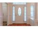 Inviting entryway with decorative door, sidelights, transom, and hardwood floors at 237 Water Front Ln, Timberlake, NC 27583