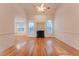 Bright living room with hardwood floors, fireplace, and elegant arch windows at 237 Water Front Ln, Timberlake, NC 27583