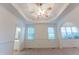 Bright main bedroom with tray ceiling, ceiling fan, neutral carpet and access to the main bathroom at 237 Water Front Ln, Timberlake, NC 27583