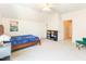 Spacious bedroom with a blue bed and an adjacent bookcase near the entrance door at 2635 High Plains Dr, Fuquay Varina, NC 27526