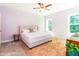 Charming bedroom with a soft rug, bright windows, and soft lavender-painted walls at 2635 High Plains Dr, Fuquay Varina, NC 27526