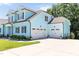 Two-car garage complementing the home's facade and ample driveway space at 2635 High Plains Dr, Fuquay Varina, NC 27526
