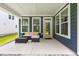Comfortable covered back porch with seating is the perfect space for relaxing outdoors at 2720 Spotted Coral Ct, Apex, NC 27502
