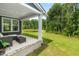Comfortable back porch with seating, offering serene views of the yard and a small pond at 2720 Spotted Coral Ct, Apex, NC 27502