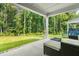 Covered back porch overlooks the grassy yard and trees, perfect for enjoying the scenery at 2720 Spotted Coral Ct, Apex, NC 27502