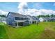 Aerial view of the backyards of the neighborhood homes with bright green grass at 2720 Spotted Coral Ct, Apex, NC 27502